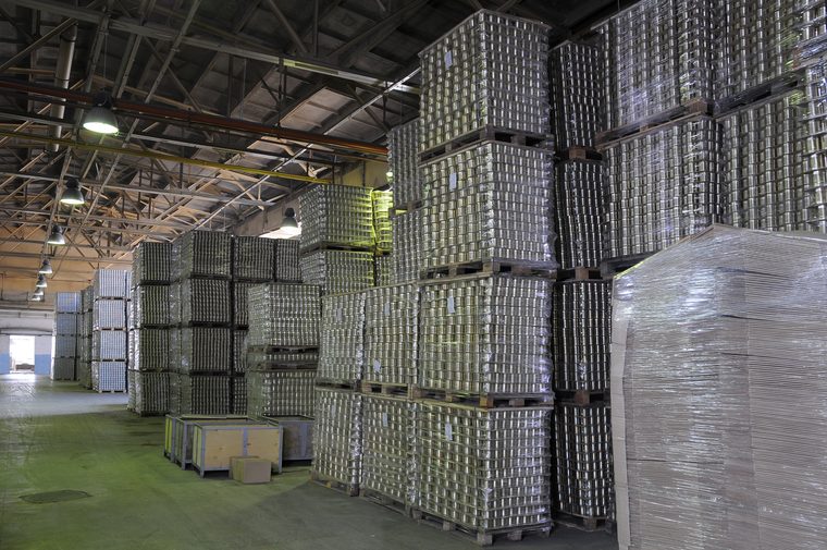 Pallets of canned product stacked in a storage warehouse