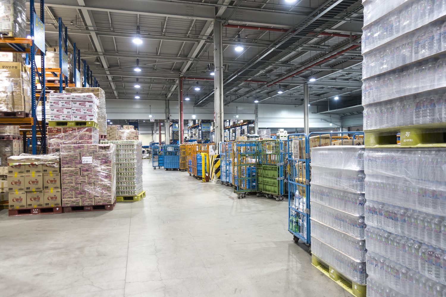Cases and pallets of bottled beverage product stored in a distribution warehouse